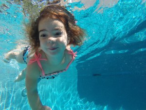 Pilar- Age 2 Using her scoops to get to the other side of the pool and play with some toys.